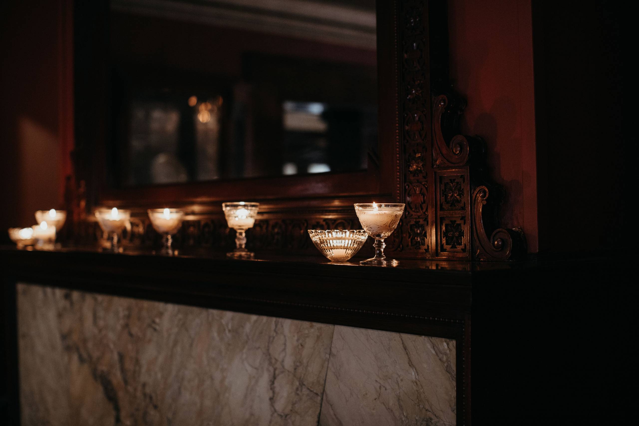 Candlelight on the mantel of the dining room fireplace at Pleasant Home